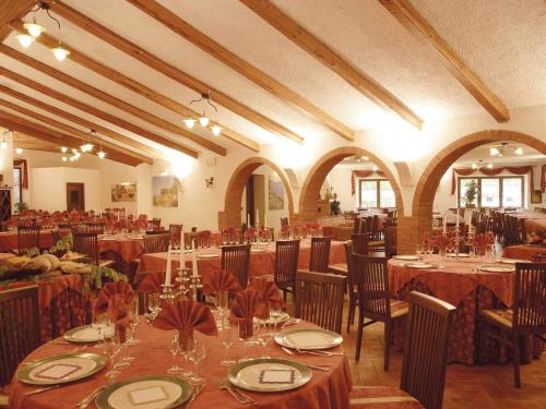 皮亚诺堡Albergo Le Macinaie - Monte Amiata的一个带桌椅的大型宴会厅