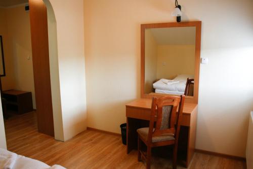 什切青Hotel 7的客房设有一张带镜子的书桌和一张床