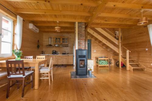 拉科维察Holiday Homes Vita Natura的小屋内的厨房和带炉灶的用餐室