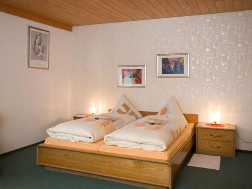 蒂蒂湖-新城Lorenzenhäusle的一间卧室配有一张床和两个带灯的床头柜