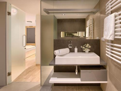扎科帕内VisitZakopane - Aquapark Residence Lux Apartment的浴室设有白色水槽和镜子