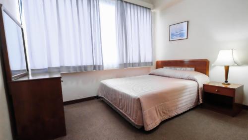 斯里巴加湾市银禧酒店的酒店客房设有床和窗户。