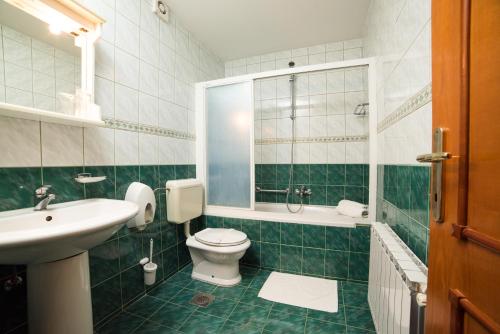 瓦拉日丁Hotel Lagus的绿色和白色的浴室设有卫生间和水槽
