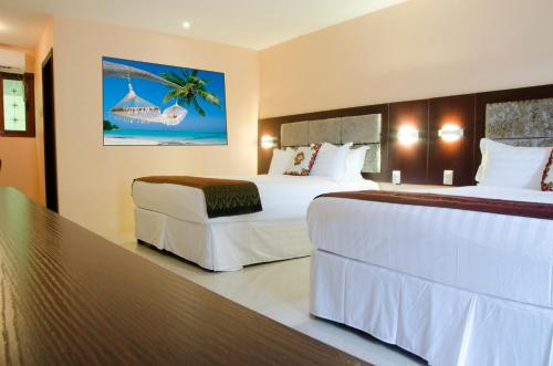 Grand Diamond Hotel Trinidad客房内的一张或多张床位