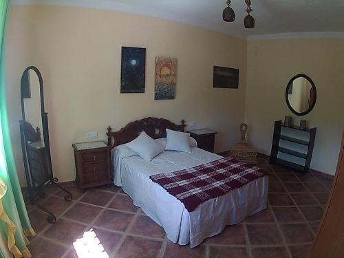 埃尔博斯克Casa Rural Entreparques的一间卧室配有一张床和镜子