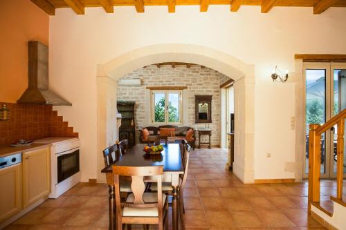 马鲁拉斯Maroulas Villa Estate的厨房以及带桌椅的起居室。