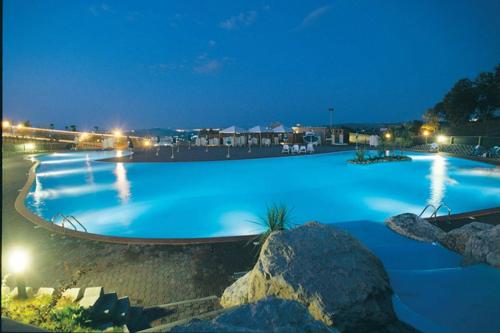 圣马力诺圣马力诺花园酒店的一座晚上有蓝色水的大游泳池