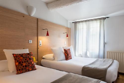 马赛艾德蒙德罗斯坦德酒店的酒店客房设有两张床和窗户。