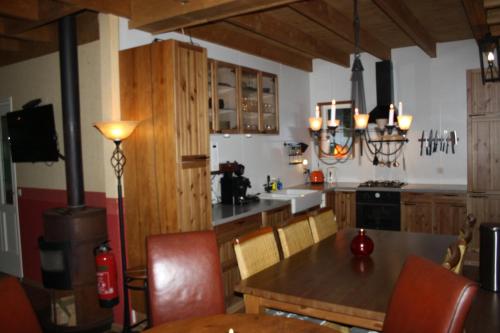 诺格Landhuis "Op de Heugte"的厨房配有桌椅和炉灶。