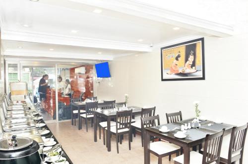 仰光邦德酒店的一间设有桌椅的用餐室和厨房内的用餐区
