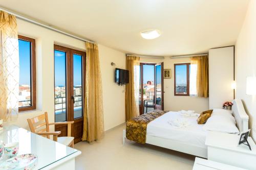 罗希姆诺Polyxenia Suites的酒店客房设有一张床和一个阳台。
