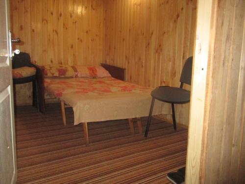 切尔卡瑟Pershyy Hostel u Cherkasah的卧室配有1张床、1张桌子和1把椅子