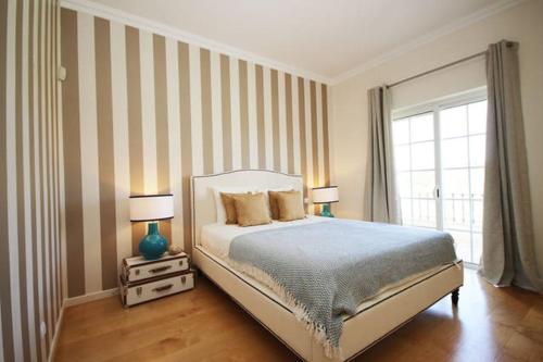 金塔湖Formosa Villas的一间卧室配有一张带两盏灯的床和一扇窗户。