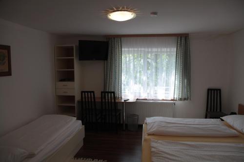 维也纳新城卡萨托颇力诺旅馆的一间卧室设有两张床和窗户。