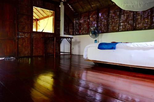 高兰安达曼向日葵酒店的客房设有一张床,铺有木地板。