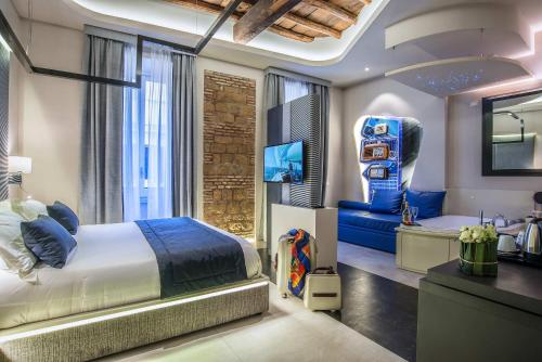 罗马威尼托大街尊贵旅馆的一间卧室配有一张床,另一间则配有电子游戏