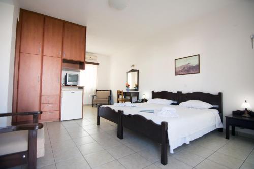 斯基罗斯岛美丽卡利酒店的一间带大床的卧室和一间厨房