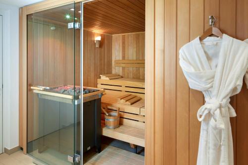 韦吉斯校园赫滕斯坦酒店的步入式淋浴间,玻璃门和毛巾