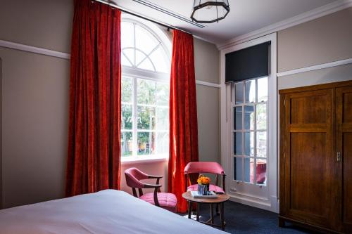 悉尼北悉尼酒店 的一间卧室配有床和红色窗帘的窗户
