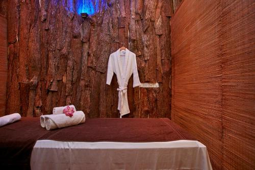 蒂瑟默哈拉默埃克霍蒂萨游猎酒店的木墙上带浴袍的床的房间