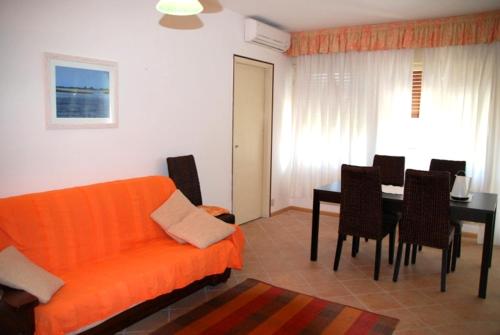 格拉多Santis Appartament的客厅配有橙色沙发和桌子