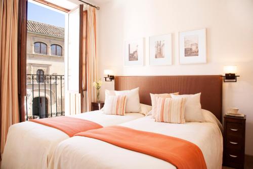 科尔多瓦拉斯卡萨斯德尔波特罗度假屋的配有窗户的酒店客房内的两张床