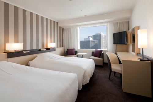 Hotel Granvia Osaka-JR Hotel Group客房内的一张或多张床位