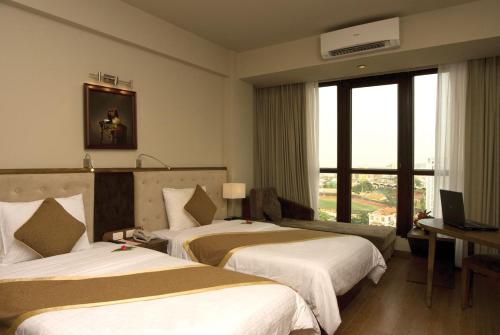顺化亚洲大酒店客房内的一张或多张床位