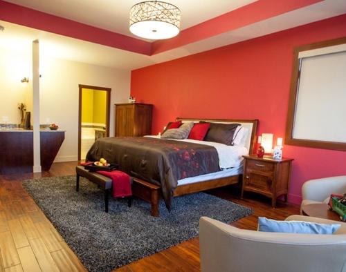 基洛纳Hillcrest Farm Market B&B的一间卧室设有一张床和红色的墙壁