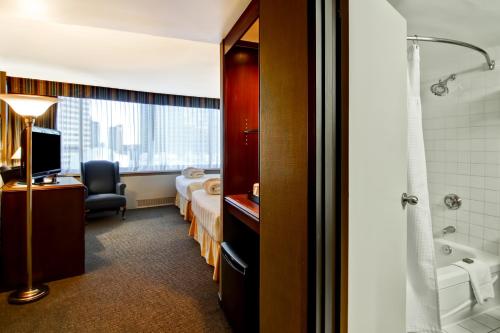 埃德蒙顿拉孔布城堡酒店的酒店客房设有带一张床和浴缸的浴室
