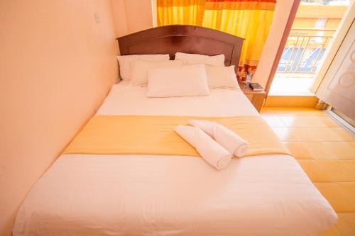 尼耶利Eland Safari Hotel Nyeri的一间卧室配有一张床,上面有两条毛巾