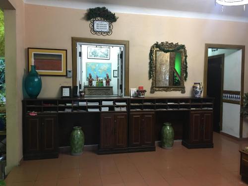 圣胡安伊比利亚半岛酒店 - 圣胡安的墙上有镜子和花瓶的房间