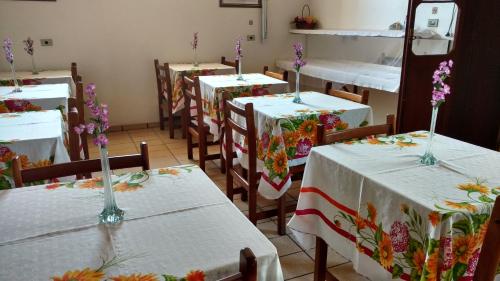 伊瓜佩Pousada Casa Grande的配有桌椅的房间,里面种有鲜花
