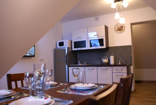 考斯赛力克Apartament Słoneczny Koscielisko的厨房配有桌椅和冰箱。