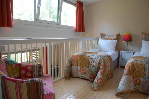 莱利斯塔德勒里马尔洛基撕旅馆的一间卧室设有两张床、一把椅子和窗户。