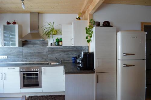 上陶恩Chalet Hamito的厨房配有白色橱柜和冰箱。
