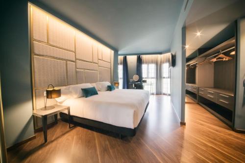 潘普洛纳潘普洛纳大教堂酒店的卧室配有一张白色大床、一张桌子和电视。