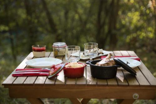 内拉克Chrysalide Saint Martin的一张野餐桌,上面放着食物和酒杯