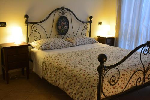 阿梅利亚里吉纳别墅酒店的一间卧室配有一张床、两盏灯和一个窗户。