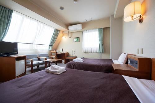 烧津站前精选旅馆客房内的一张或多张床位
