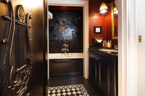 巴黎埃斯特雷马杜拉别墅酒店的带淋浴和盥洗盆的黑色浴室