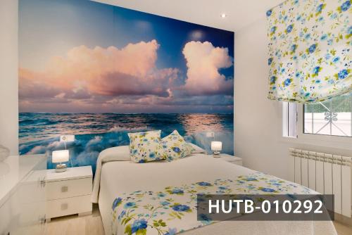 锡切斯Apartamento Roca Mar的一间拥有海洋壁画的卧室