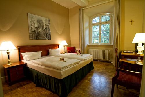戈斯拉尔沃蒂洛德克罗斯特酒店的一间卧室设有一张大床和一个窗户。