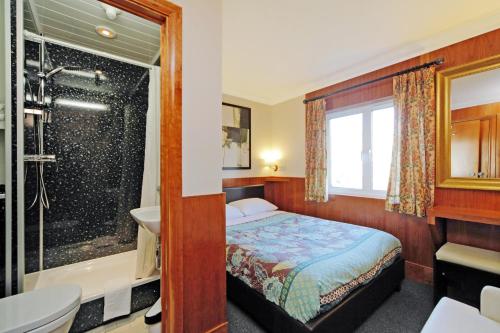 伦敦伦敦维森特酒店的一间卧室配有一张床、淋浴和盥洗盆