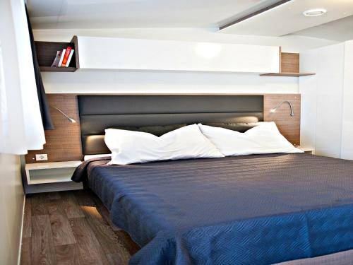 帕科坦Auto kamp Cuka的一间卧室配有一张带黑色床头板的床