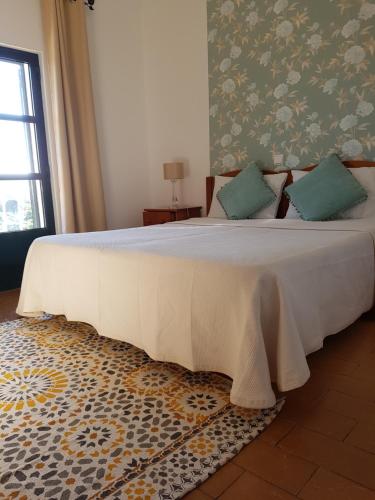 萨格里什卡博德圣玛丽亚酒店的卧室配有带绿色枕头的大型白色床