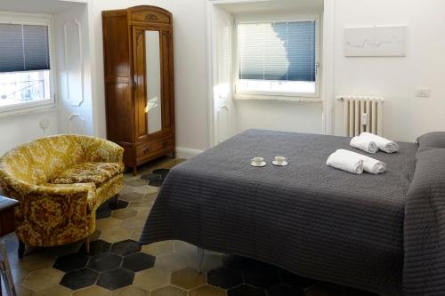 罗马La Rosa del Vaticano Luxury Apartment的一间卧室配有一张带椅子和毛巾的床