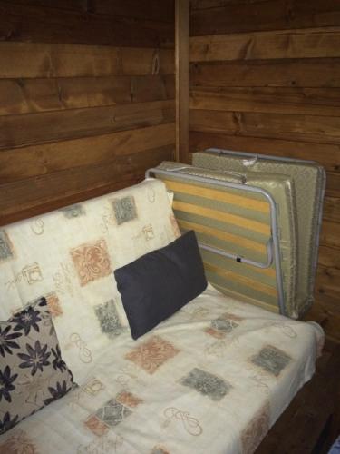 ElaiokhórionSarakina Wooden House的木房内的一张小床,配有四柱床