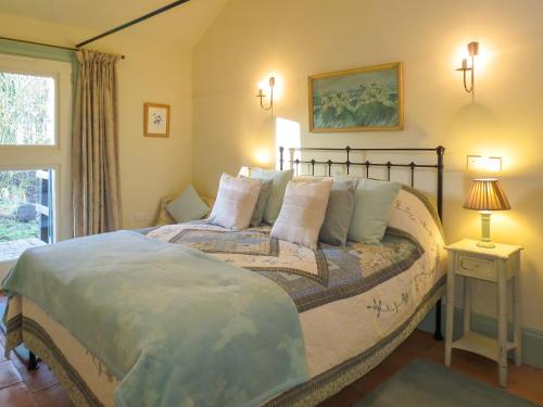 FressingfieldAppletree Cottage Fressingfield的一间卧室设有一张大床和一个窗户。