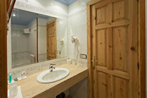 塞特卡萨斯拉科马酒店的一间带水槽和镜子的浴室